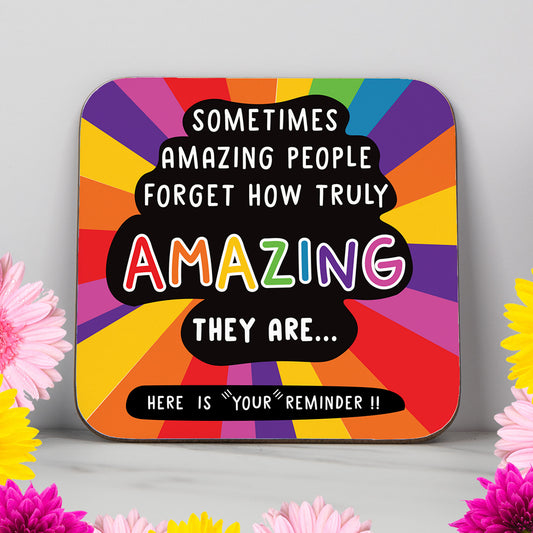 Inspirational coaster with bold black burst background and uplifting text that reads "Sometimes Amazing People Forget How Truly Amazing They Are... This is your reminder!!" – a motivational and heartwarming gift designed to boost confidence and show appreciation. Ideal as a thank you gift, mental health pick-me-up, or positivity present for a friend, colleague, or loved one. Vibrant and meaningful desk decor.