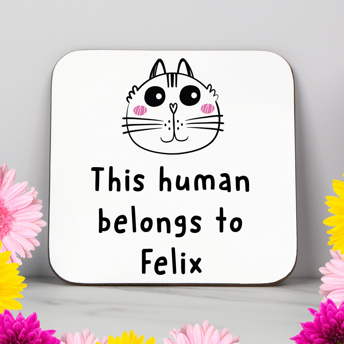 White coaster with the phrase "This Human Belongs To [CAT NAME]" and cute cat illustration – a personalised gift for cat lovers, cat mums, and proud pet owners