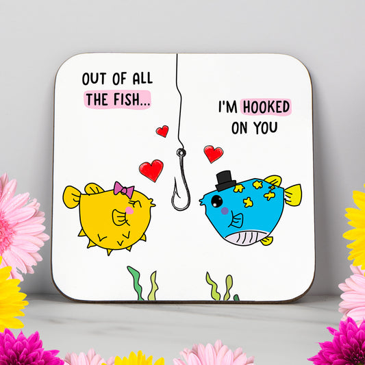 Valentine’s Day coaster featuring two cartoon fish with hearts and the pun "I'm Hooked On You" – funny and romantic gift for boyfriend, girlfriend, husband or wife. Cute and playful love-themed coaster with a glossy finish, ideal for Valentine’s Day, anniversary, or romantic surprise. Perfect for couples, fish lovers or anyone who enjoys a lighthearted pun. Great gift idea for him or her to make them smile.